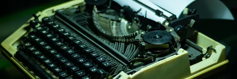 A mechanical teletype machine with its printing head exposed