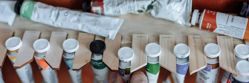 Open tubes of artist's paint arranged by colour