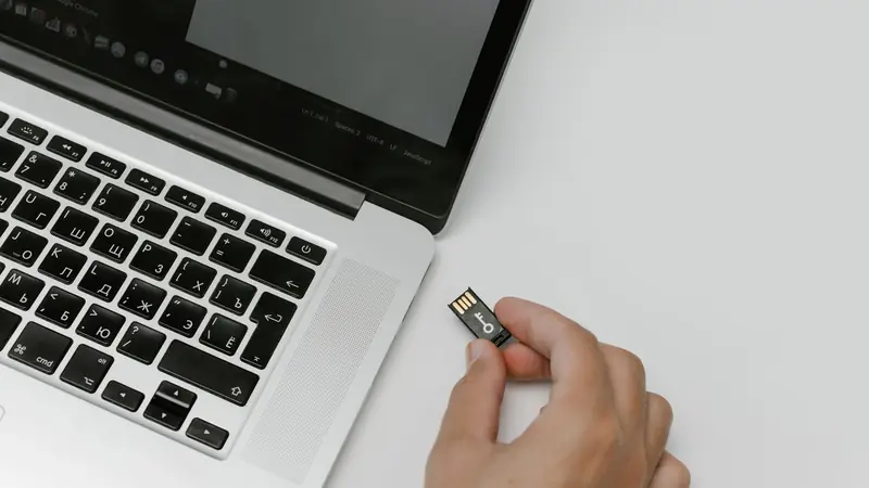 A USB flash drive and memory cards arranged on a plain surface