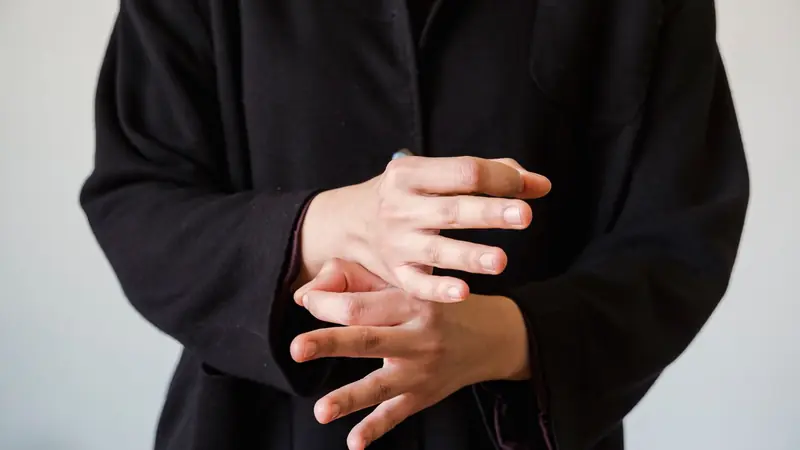A pair of hands held up mid-count