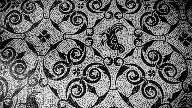 A black and white mosaic of small square tiles