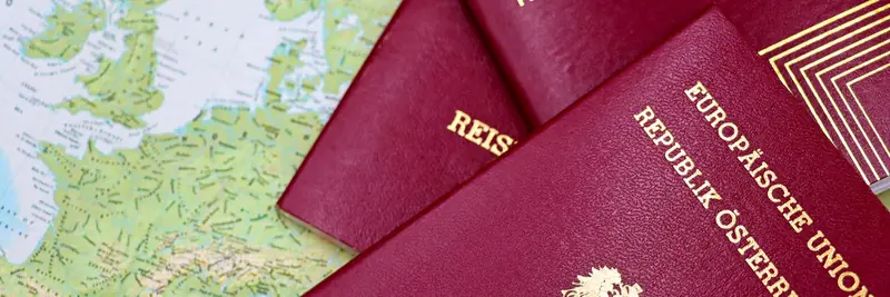 A passport and boarding pass on a travel desk