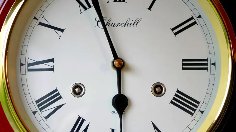 An antique clock face marked with Roman numerals