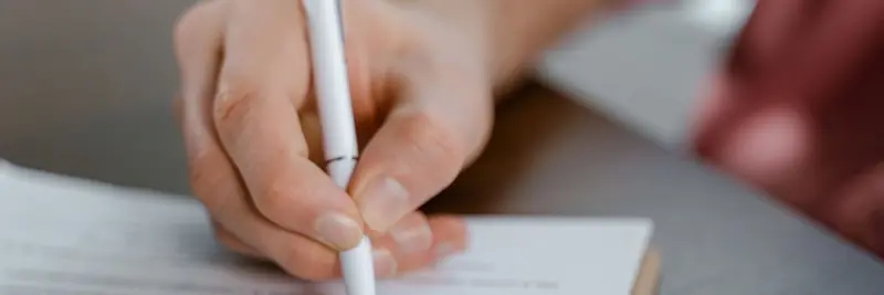 A printed agreement and a pen on a desk